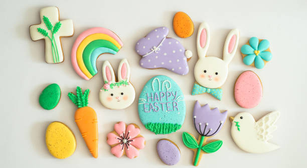 Happy Easter. Multicolored pastel easter cookies in a wicker basket  on a wood background