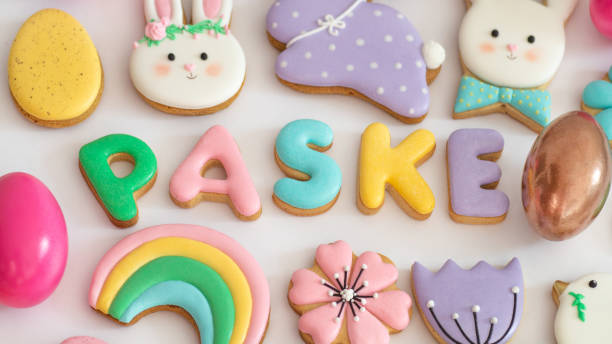 istock Happy Easter. Multicolored pastel easter cookies in a wicker basket  on a wood background 1201666789