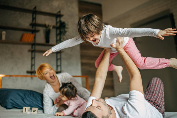 istock Family cuddling in bed 1201668573