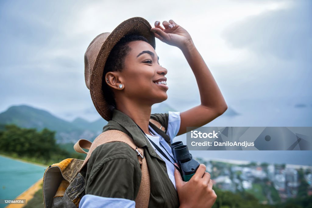 Happy girl climber on break Portrait of young afro woman explorer Travel Stock Photo