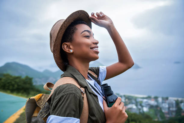 Happy girl climber on break Portrait of young afro woman explorer binoculars photos stock pictures, royalty-free photos & images