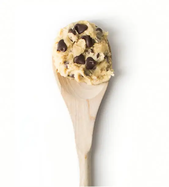 Photo of Chocolate chip cookie dough on a wooden spoon