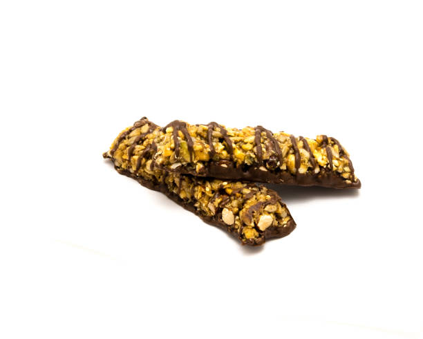 istock Two organic dark chocolate protein bars with healthy nuts isolated on white 1201670362