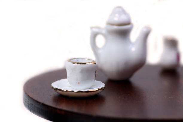 istock doll house interior - tea-service on the table against white background 1201670864