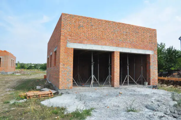 Garage under construction. Building new brick wall garage for two cars without garage doors.