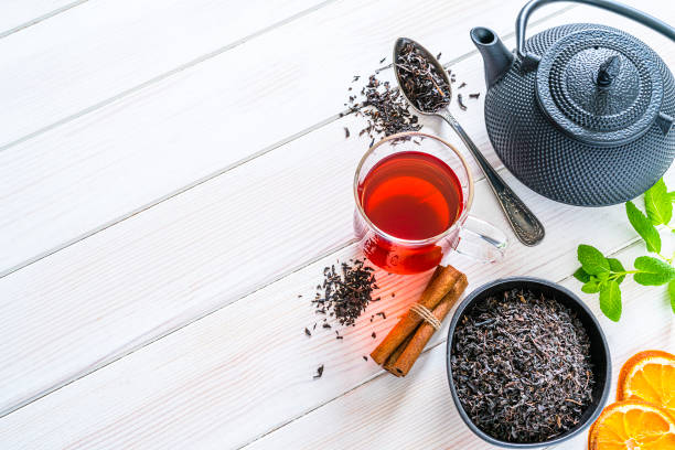istock Black tea cup shot from above on white table. Copy space 1201672962