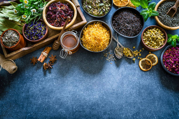 istock Various dried tea leaves and flowers shot from above on bluish table. Copy space 1201673523