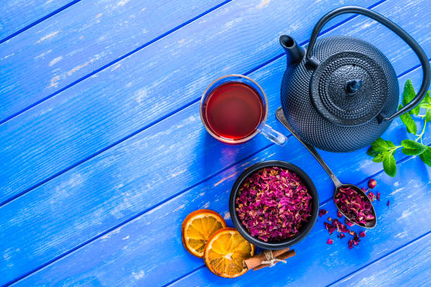 istock Rose petals tea shot from above on blue background. Copy space 1201673558