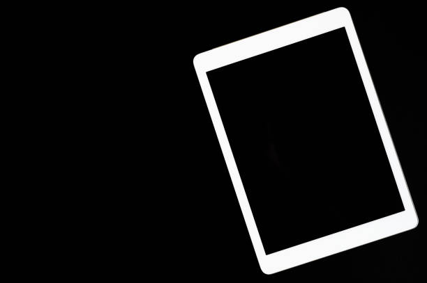 istock white tablet turned off on a black background. minimal black white concept. space for text 1201674109