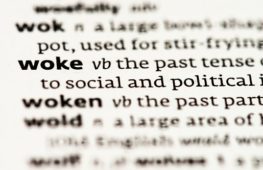 A close-up of the word 'woke', and a part of the word's definition, related to social awareness.