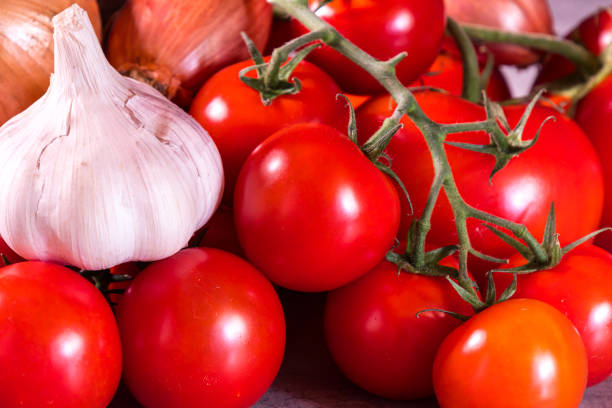 istock assorted garlic tomatoes and onions for a kitchen decoration poster 1201674440