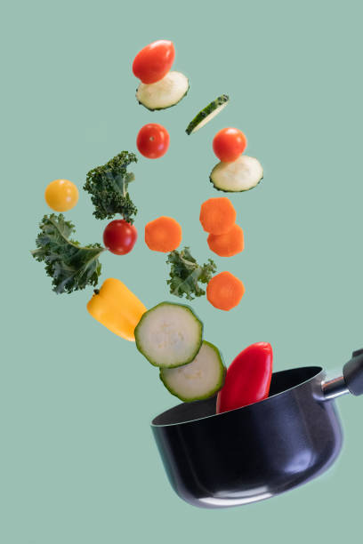 istock Saucepan with assorted vegetables flying in the air 1201674888