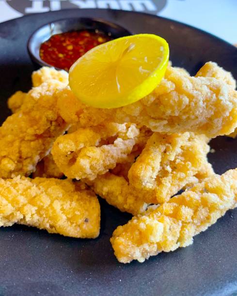 istock Fried calamari with lemon and red chilli dice 1201674960