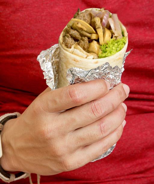 Burrito wrap filled with mushrooms beef and lettuce