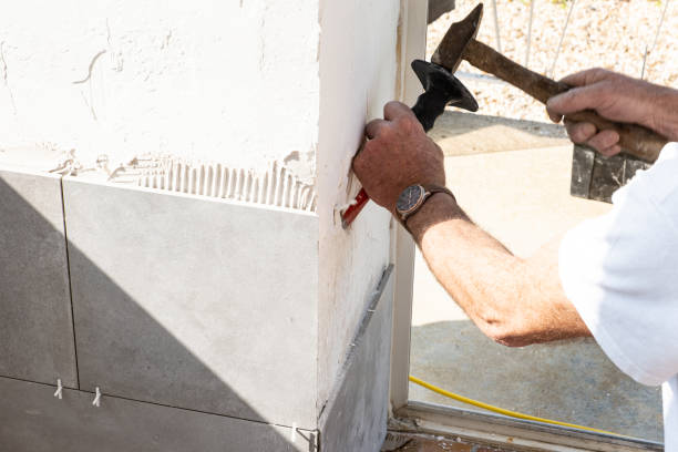 istock the mason prepares the wall with a chisel before laying a ceramic tile 1201679359