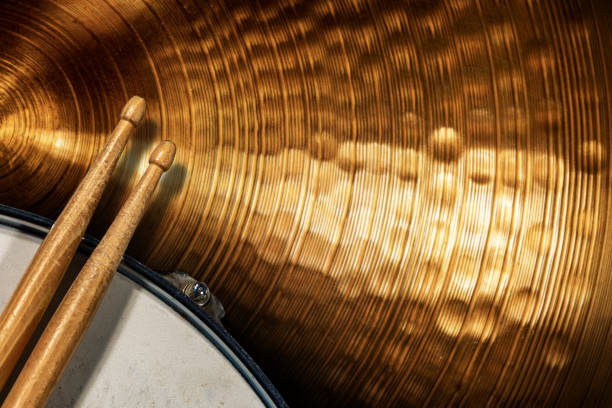 Two wooden drumsticks on a snare drum and golden cymbal - Percussion instrument Close-up of two wooden drumsticks on an old metallic snare drum and golden colored cymbal with copy space. Percussion instrument drum kit photos stock pictures, royalty-free photos & images