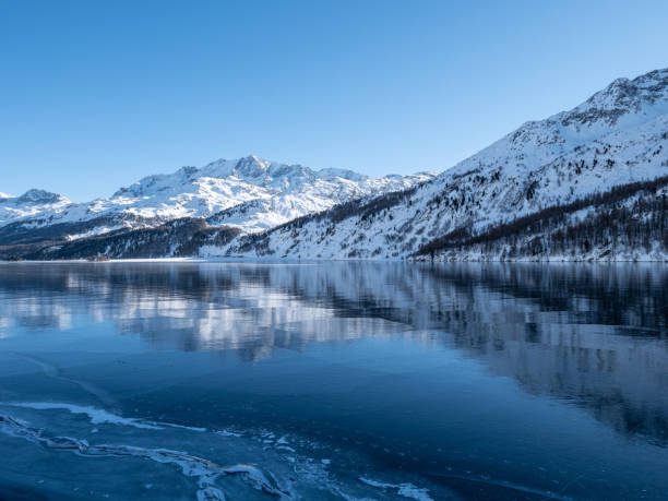 istock Frozen lake and snowcapped mountain in Switzerland 1201682411