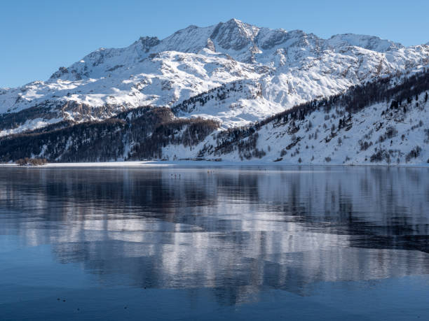 istock Frozen lake and snowcapped mountain in Switzerland 1201682588
