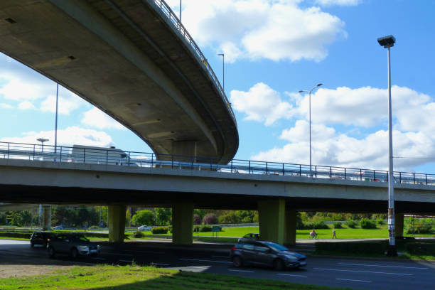 istock low angle view of concrete overpass highway underside and light street traffic 1201682769