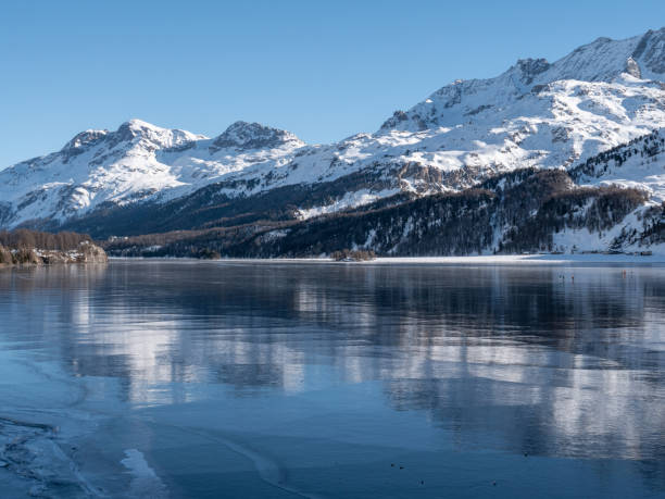 istock Frozen lake and snowcapped mountain in Switzerland 1201682818