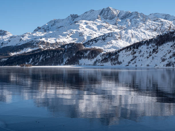 istock Frozen lake and snowcapped mountain in Switzerland 1201683434