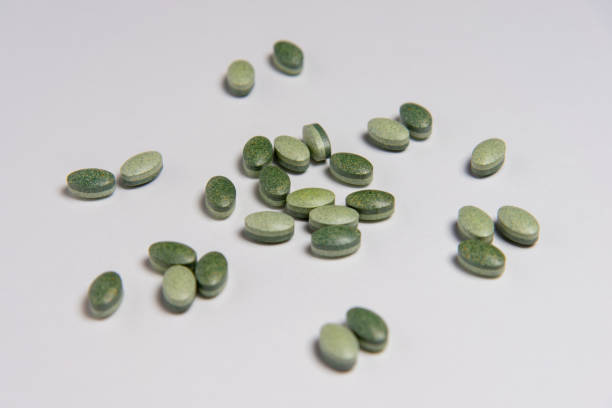 istock green medicine pills on white background 1201683592