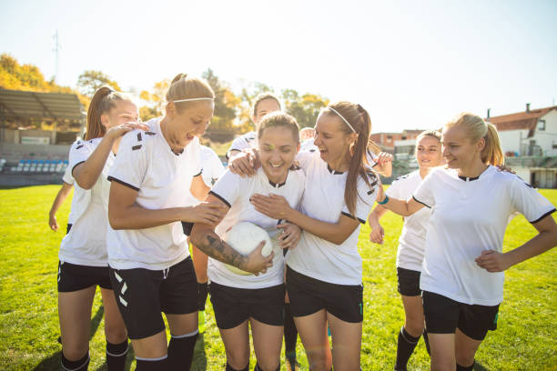 istock Female soccer team celebrating after scoring a goal 1201684314