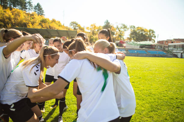 istock Female soccer team cheering and celebrating after a win 1201684332