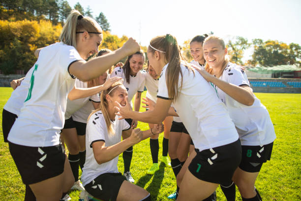 istock Female soccer team celebrating a victory together 1201684901