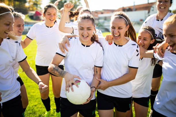 istock Female soccer team celebrating a goal during match 1201685508