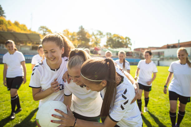 istock Female soccer team celebrating after scoring a goal 1201685585