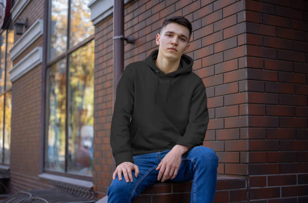 istock Mockup of an empty hoodie on a young guy in blue jeans, front view. 1201685787
