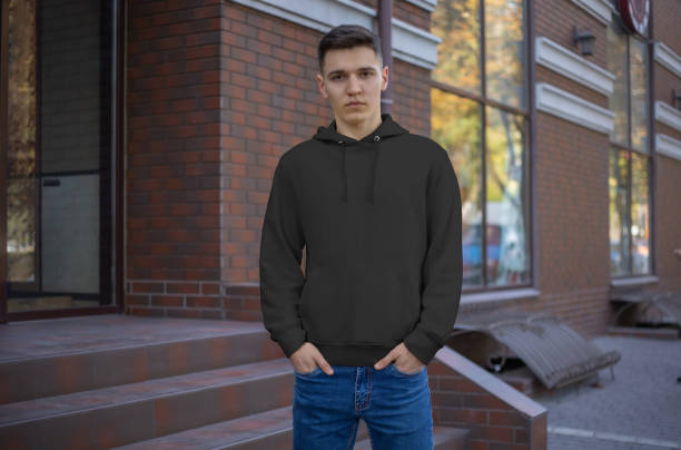 istock Template of a black hoodie on a young guy, front view. 1201685808