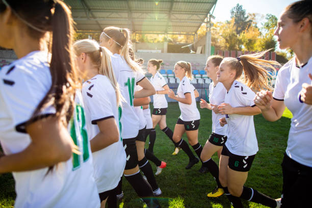 istock Woman soccer team running on training grounds 1201686021