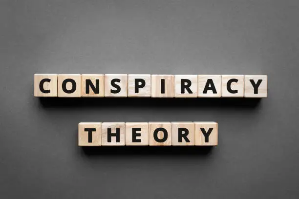 Conspiracy theory - words from wooden blocks with letters, a secret plan powerful people, conspiracy theory concept, top view gray background