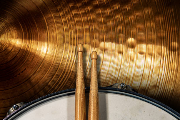 Two wooden drumsticks on a snare drum and golden cymbal - Percussion instrument Close-up of two wooden drumsticks on an old metallic snare drum and golden colored cymbal with copy space. Percussion instrument snare drum photos stock pictures, royalty-free photos & images