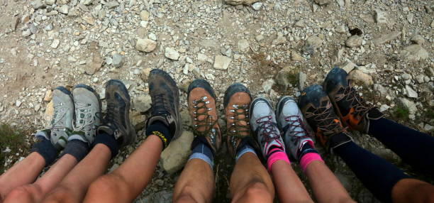 family of five people with climbing boots in mountain