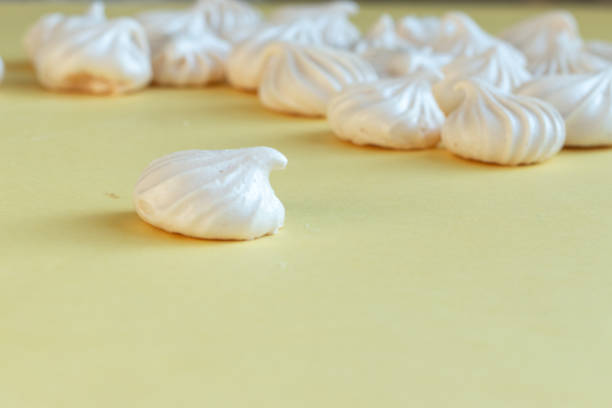 istock White delicious merengue on a yellow background 1201690013