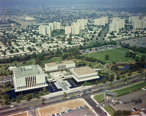 Aerial view of Los Angeles County Museum of Art, Los Angeles, California in 1966 shortly after the 1965 opening. The buildings front on Wilshire Boulevard and are surrounded by fountains and reflecting pools. The fountains and pools have removed due to oil and gas seepage into the water from the La Brea Tar Pits and the entrance moved to the opposite side. Scanned film.
