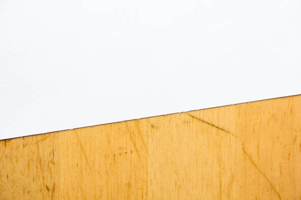 istock White blank sheet of drawing paper on brown wooden table background. Copy space for text message. 1201690400