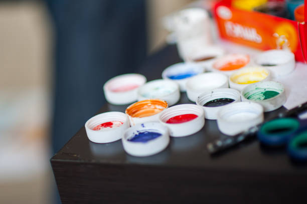 istock Artist's workshop. Canvas, paint, brushes, palette knife lying on the table. 1201693212