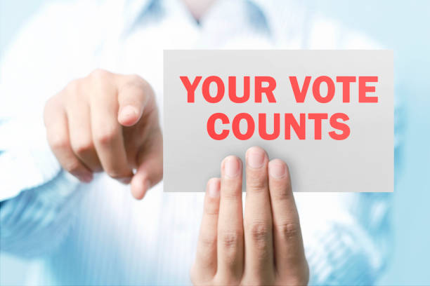 istock Man holding placard saying your vote counts 1201693651