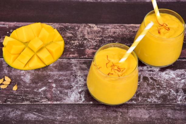 istock Mango Lassi, Indian popular summer drink served in glass garnish with saffron 1201695458