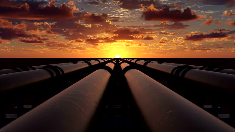 Pipeline transportation of oil, natural gas or water through metal pipes. Concept of the oil refining industry. The camera moves over six pipeline streams right at sunset