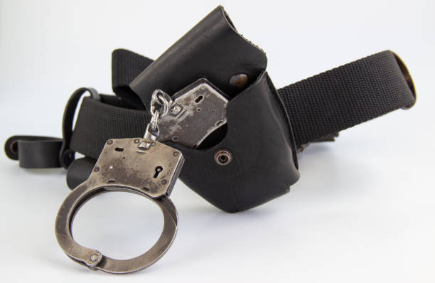 istock real police handcuffs with case and belt isolated on white background 1201706742