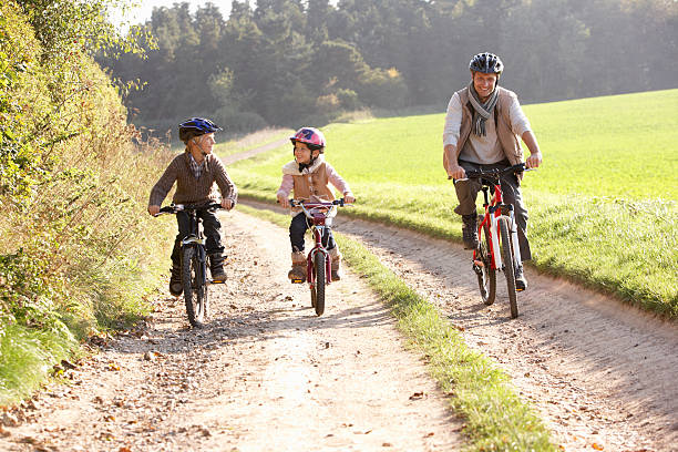istock Young father with children riding bikes in park 120170689