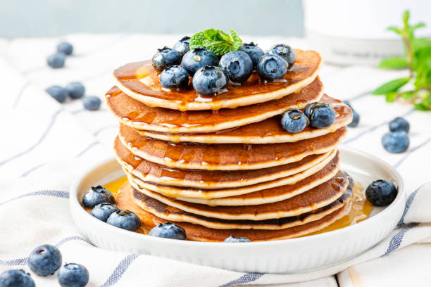 istock Pancakes with maple syrup and blueberries close-up. 1201708055