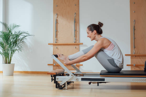 istock Sportswoman Doing Exercise on Pilates Reformer 1201708201