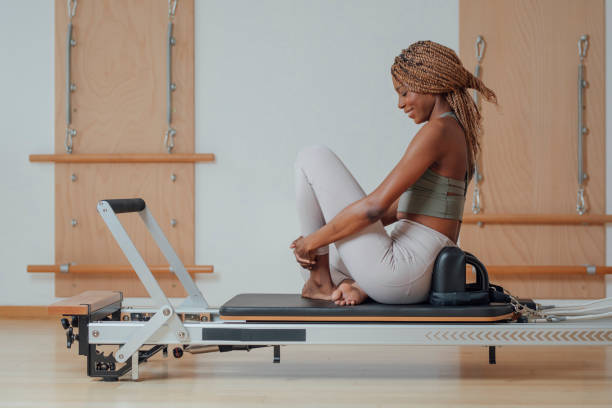 istock Sportswoman Sitting on Pilates reformer 1201708221