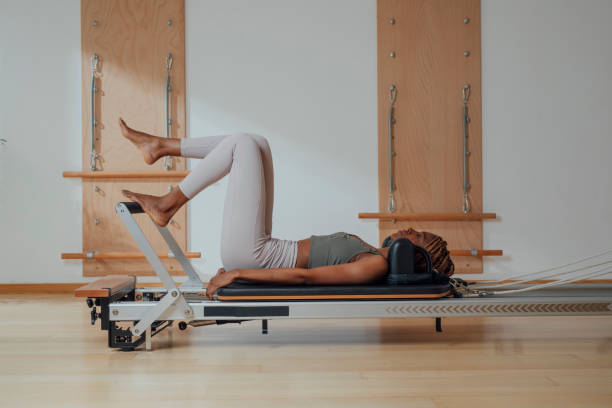 istock Sportswoman Doing Exercise on Pilates Reformer 1201708229
